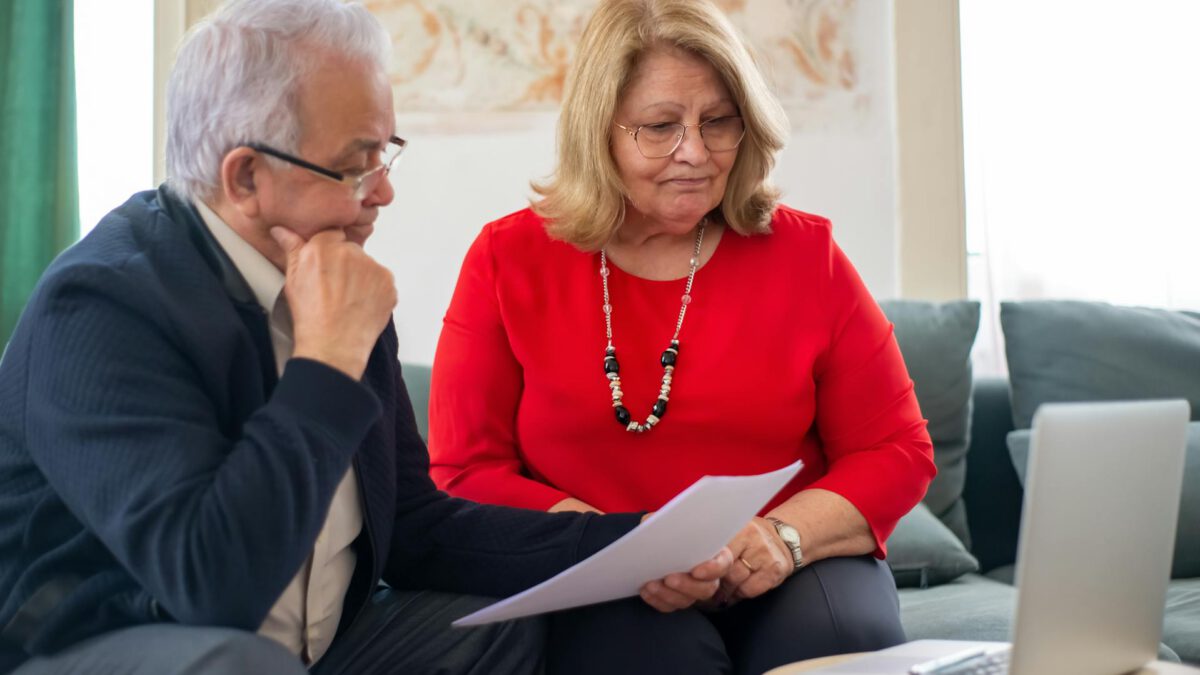 Edmonton couple reviewing mortgage pre-approval and credit score documents at home