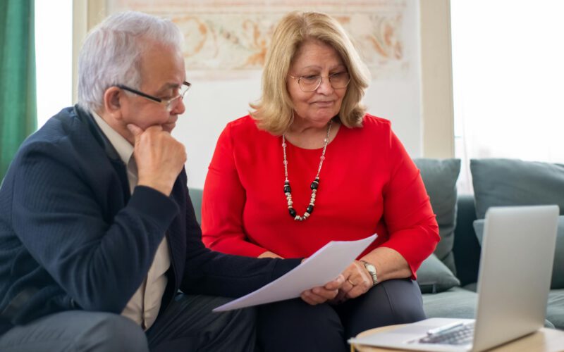 Edmonton couple reviewing mortgage pre-approval and credit score documents at home