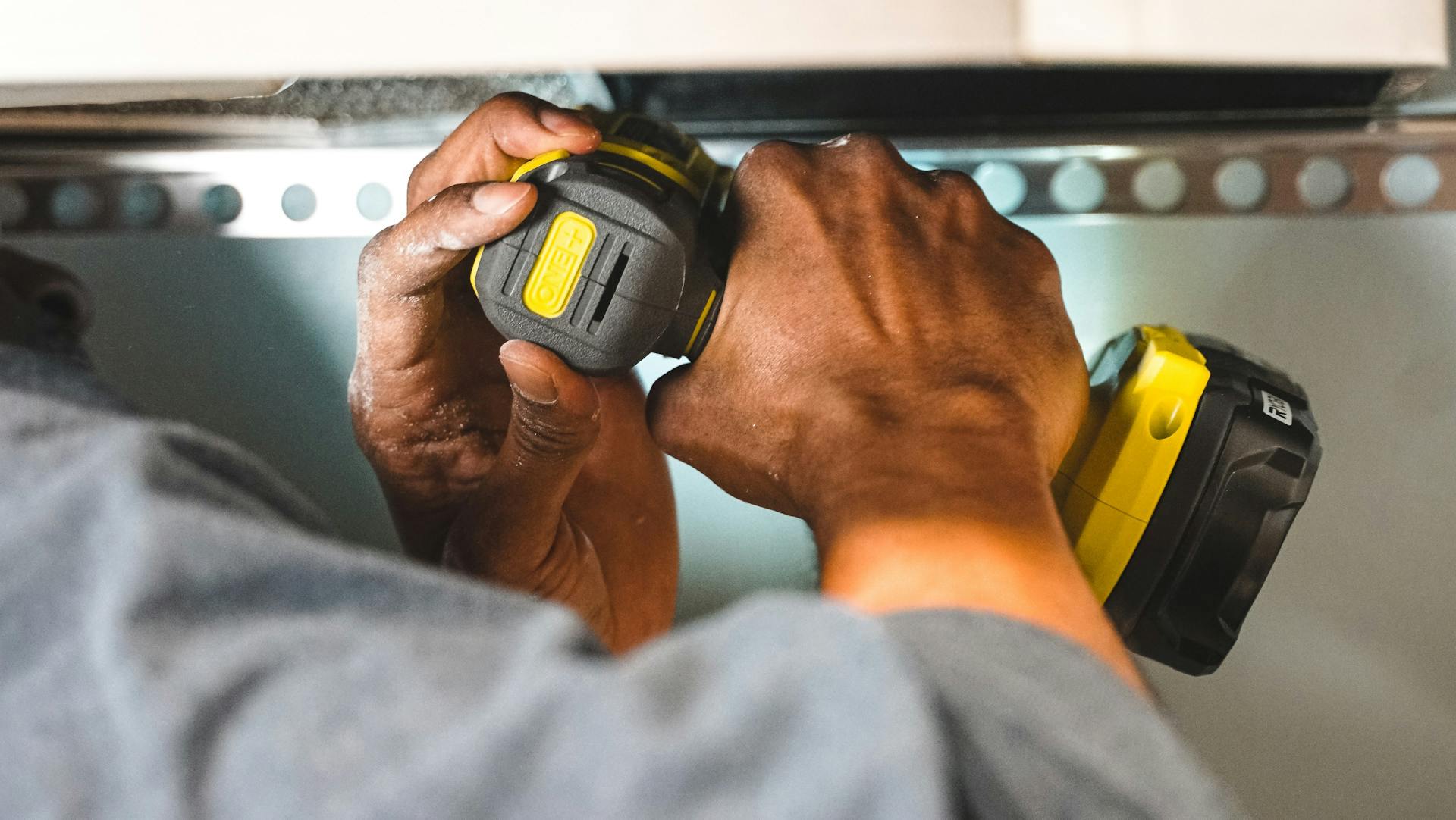 Installing new cabinet hardware as affordable kitchen update before listing Edmonton home