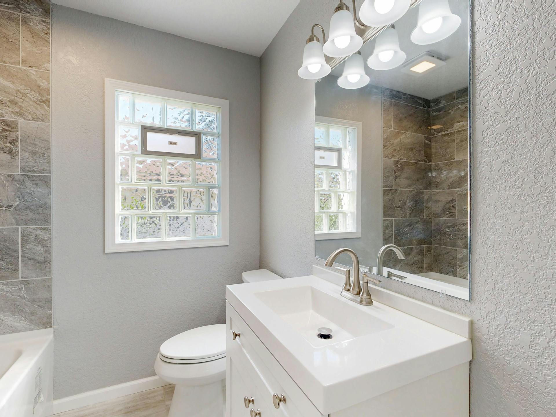 Freshly updated Edmonton bathroom with new caulking and clean accessories ready for showings