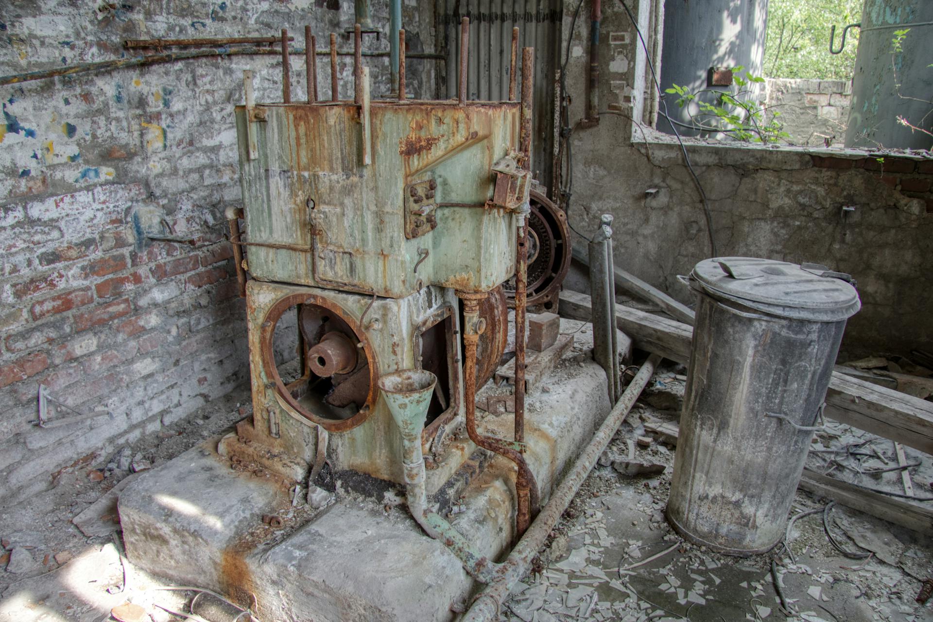 Furnace and hot water tank in Edmonton home utility room showing equipment age