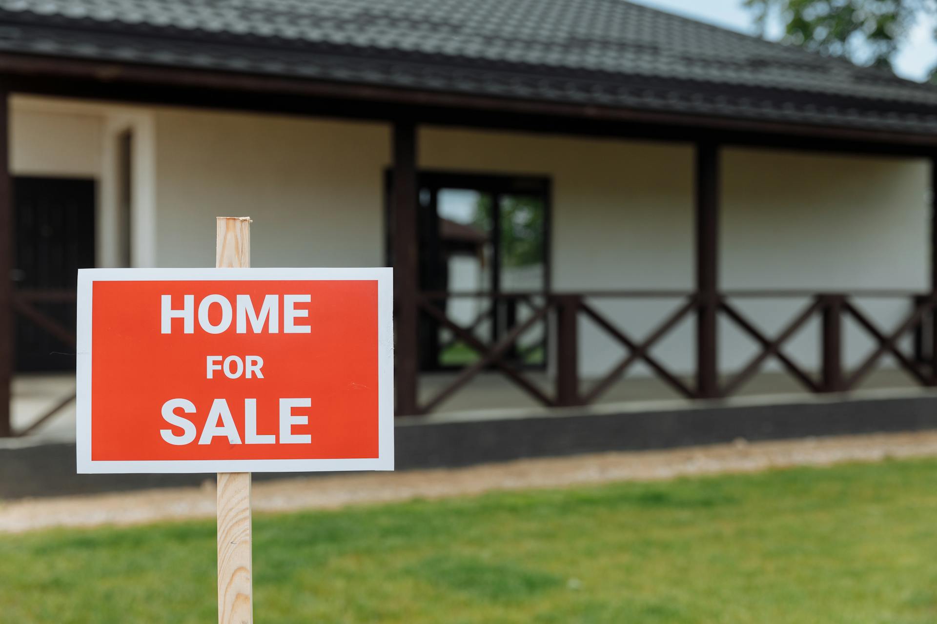 Single-story Edmonton home with a for-sale sign on a residential lawn, similar in scale and footprint to the post-war bungalow stock that dominates North Glenora.