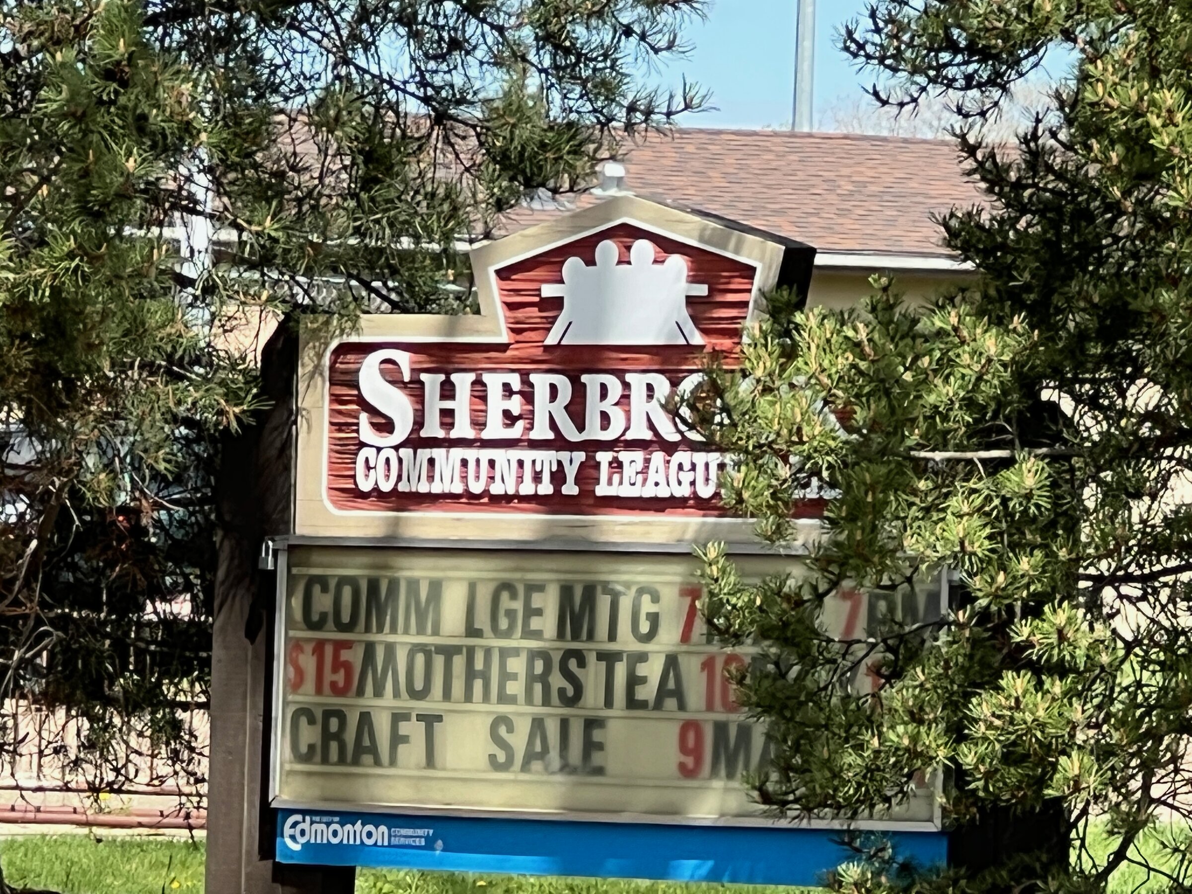 Sherbrooke Community League sign with event listings in front of the community hall, northwest Edmonton