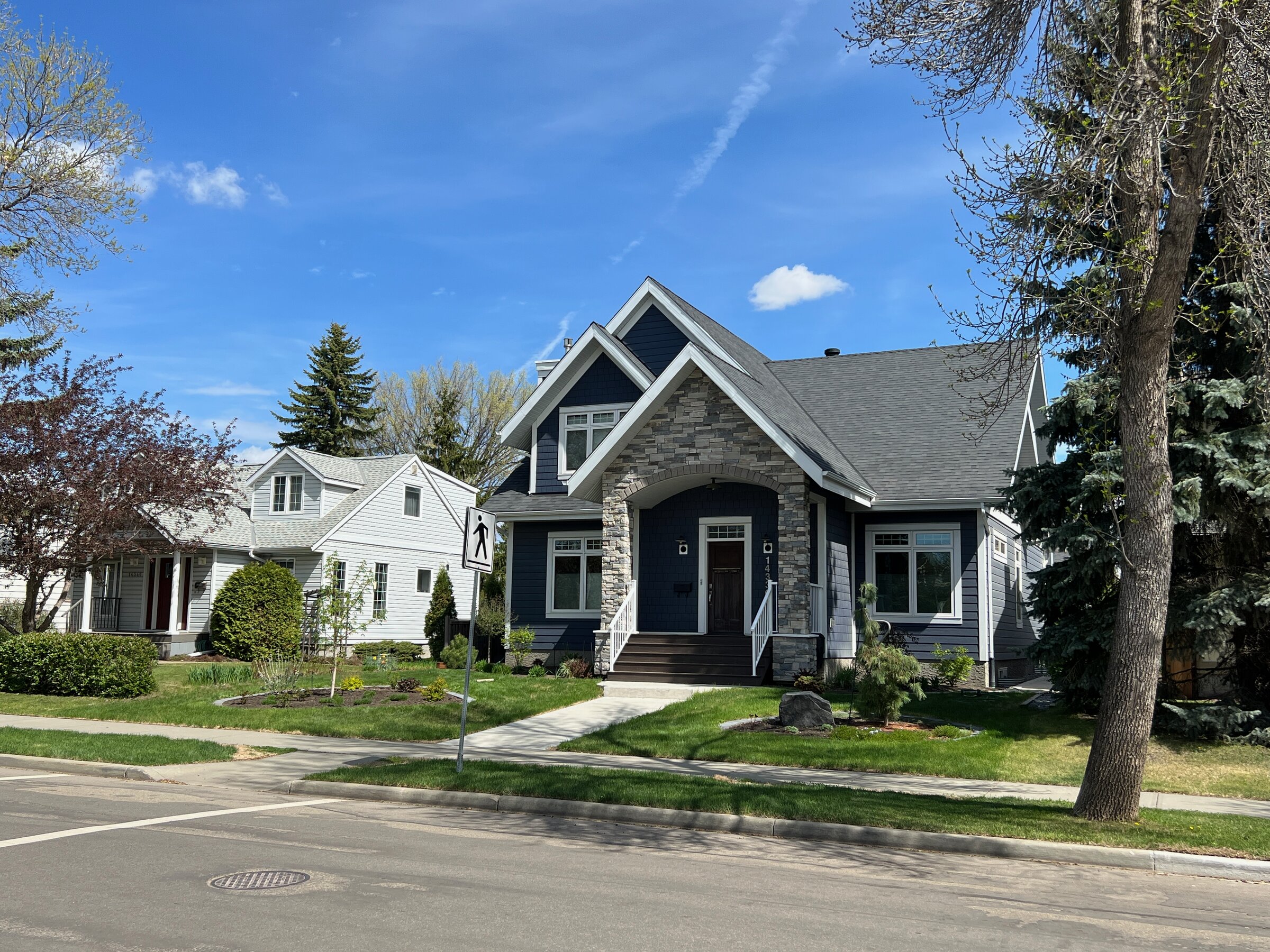 A renovated 1.5-storey character home with stone accents in Crestwood, Edmonton