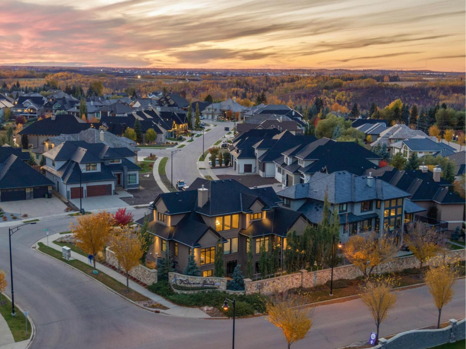 Aerial view of large detached homes in an upscale residential neighbourhood under autumn colour, typical of the estate tier of homes for sale in Windermere, Edmonton